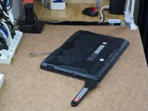 裏フタ隙間にヘラを差し込んでいる写真